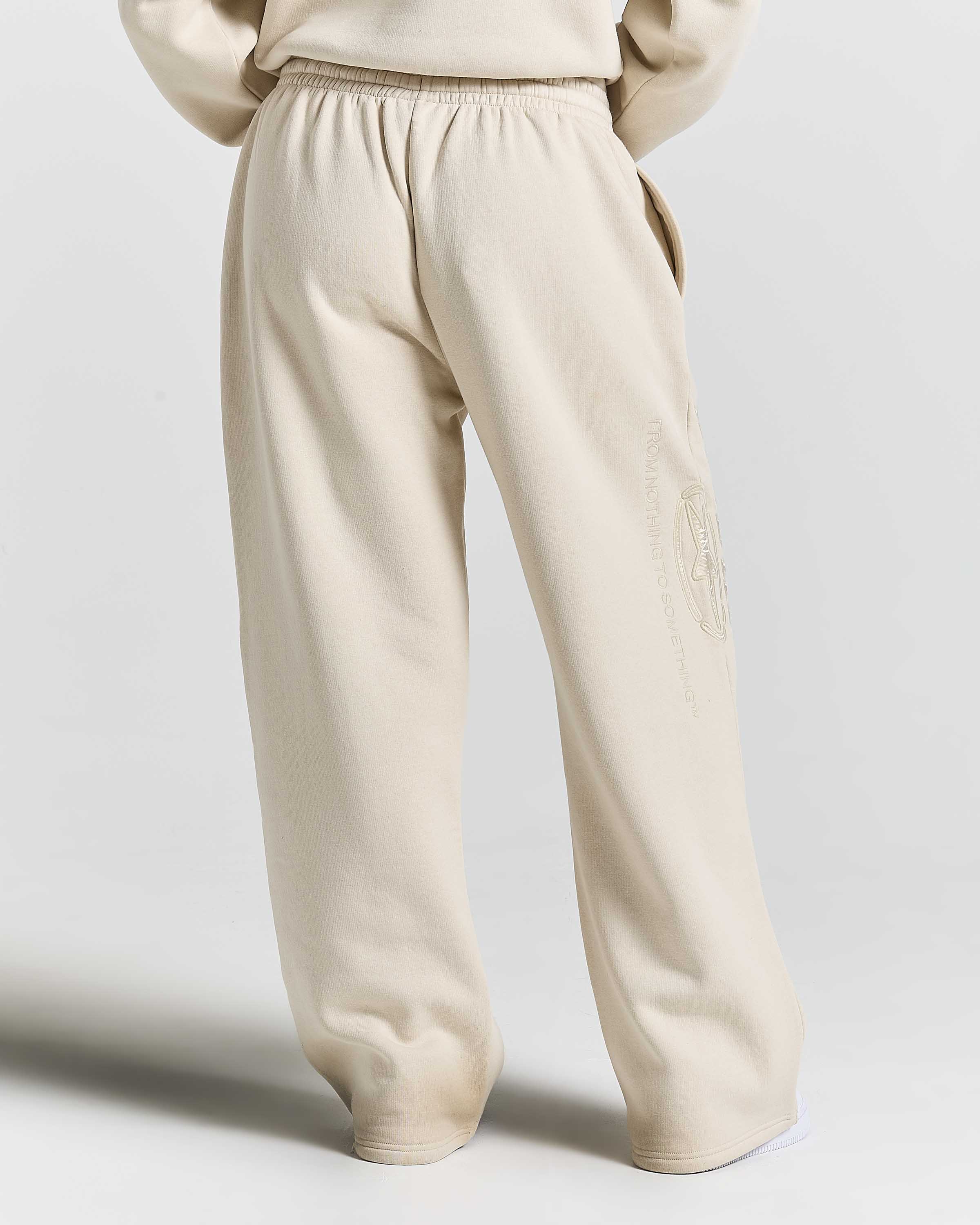 Displays a model wearing the Stone 'Hoodrich' branded women's Aegis Full Tracksuit