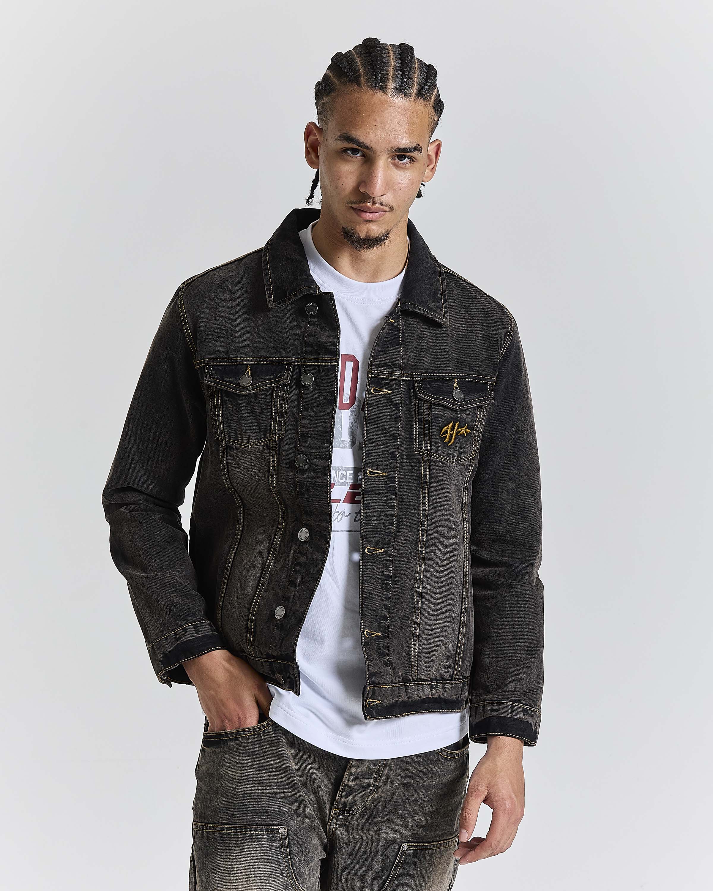 Model wearing a regular fit black rust washed denim jacket with Hoodrich logo embroidery on the chest pocket.