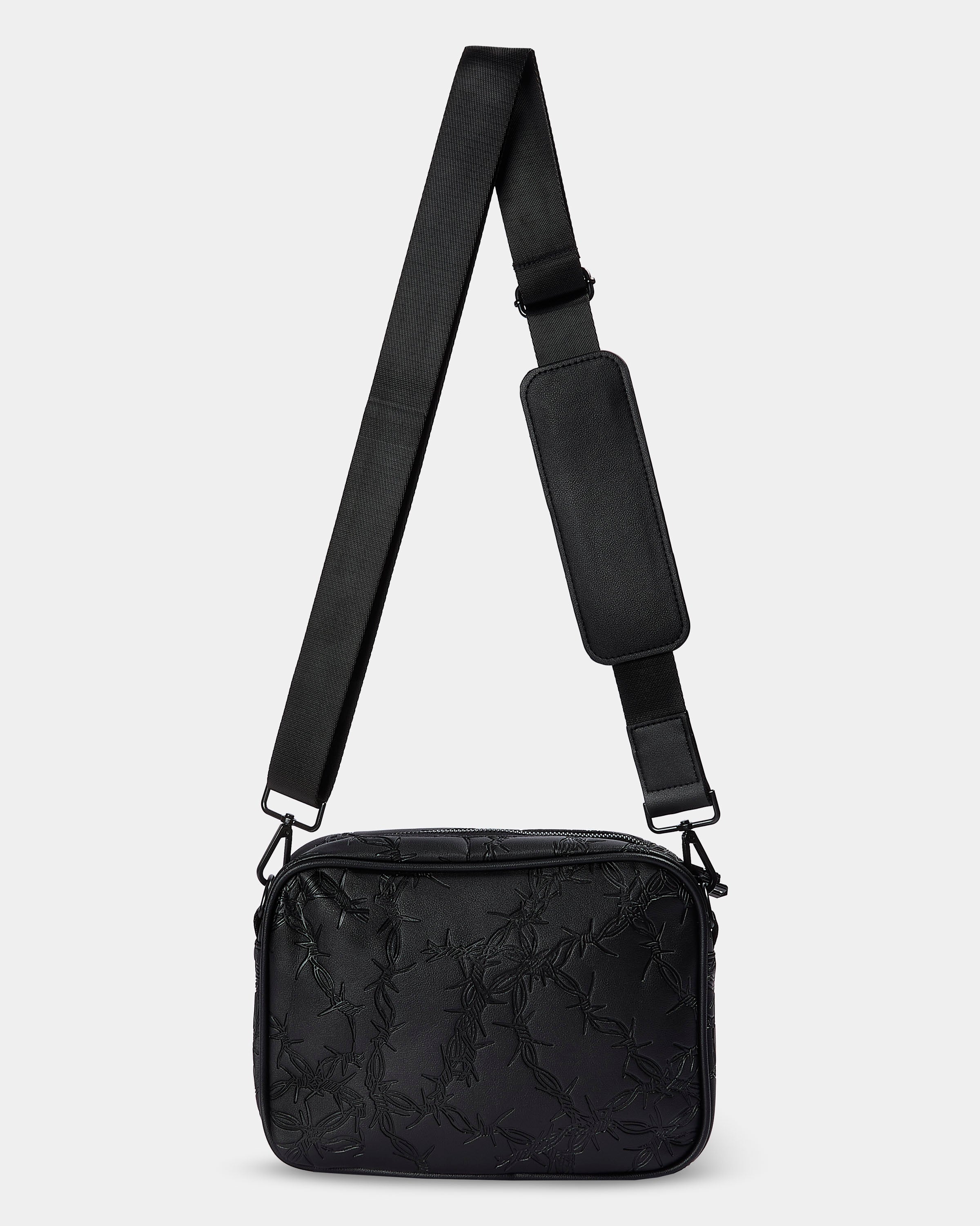 Black crossbody bag with a strap on a light gray background