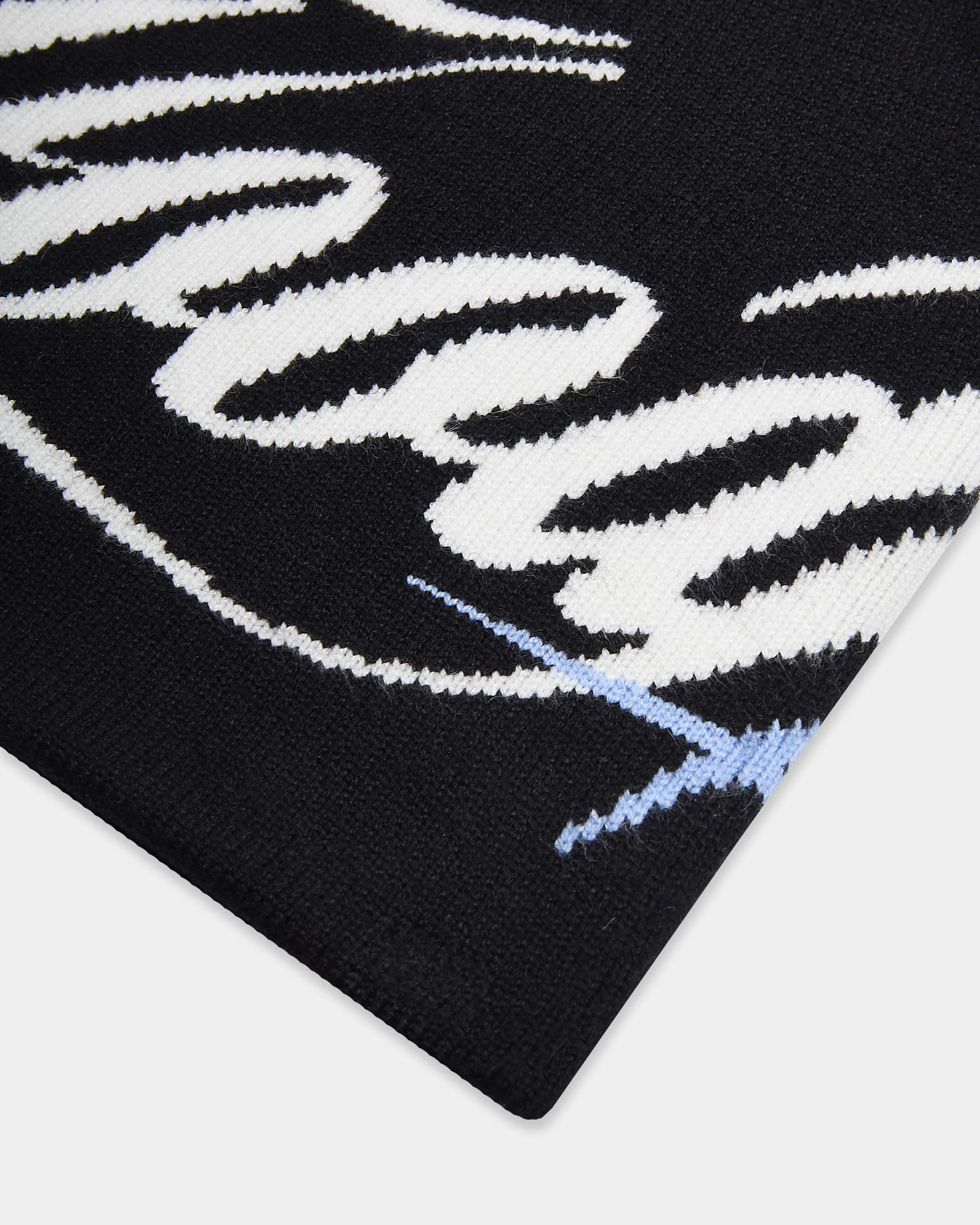 Black and white patterned fabric with a blue line on a white background