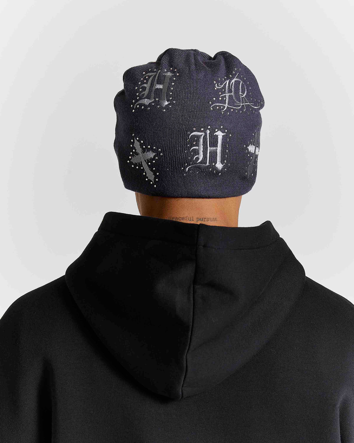 Displays a model wearing the grey 'Hoodrich' branded Scar Knitted Fitted Beanie