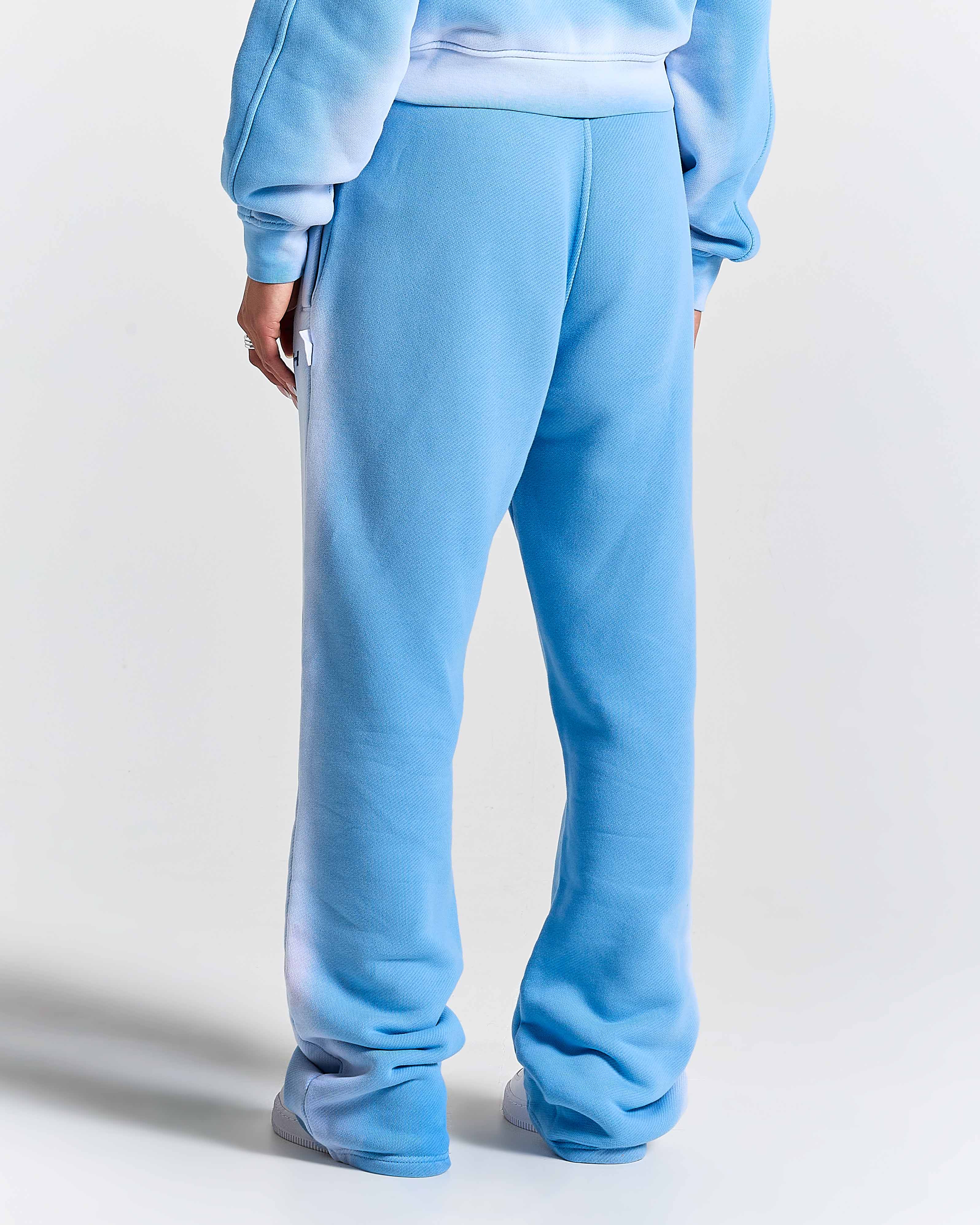 Light blue sweatpants worn by a model on a white background