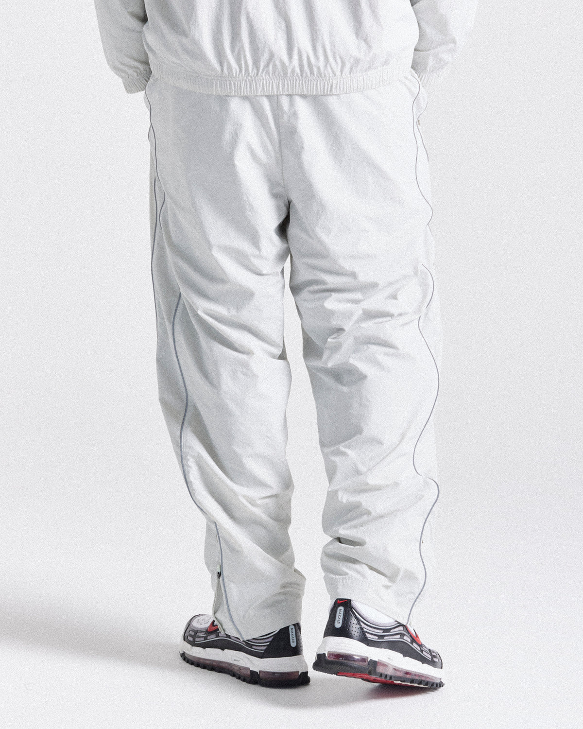 Displays a model wearing the Grey 'Hoodrich' branded men's Cypher Woven Full Tracksuit