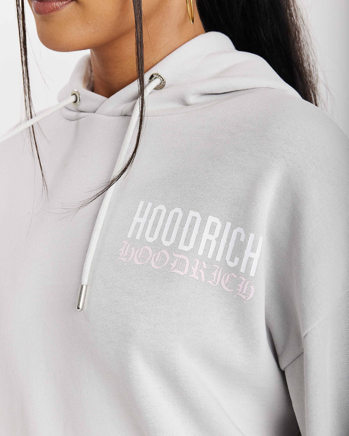 Displays a model wearing the Grey 'Hoodrich' branded women's Flex Full Tracksuit featuring the hoodrich branding details