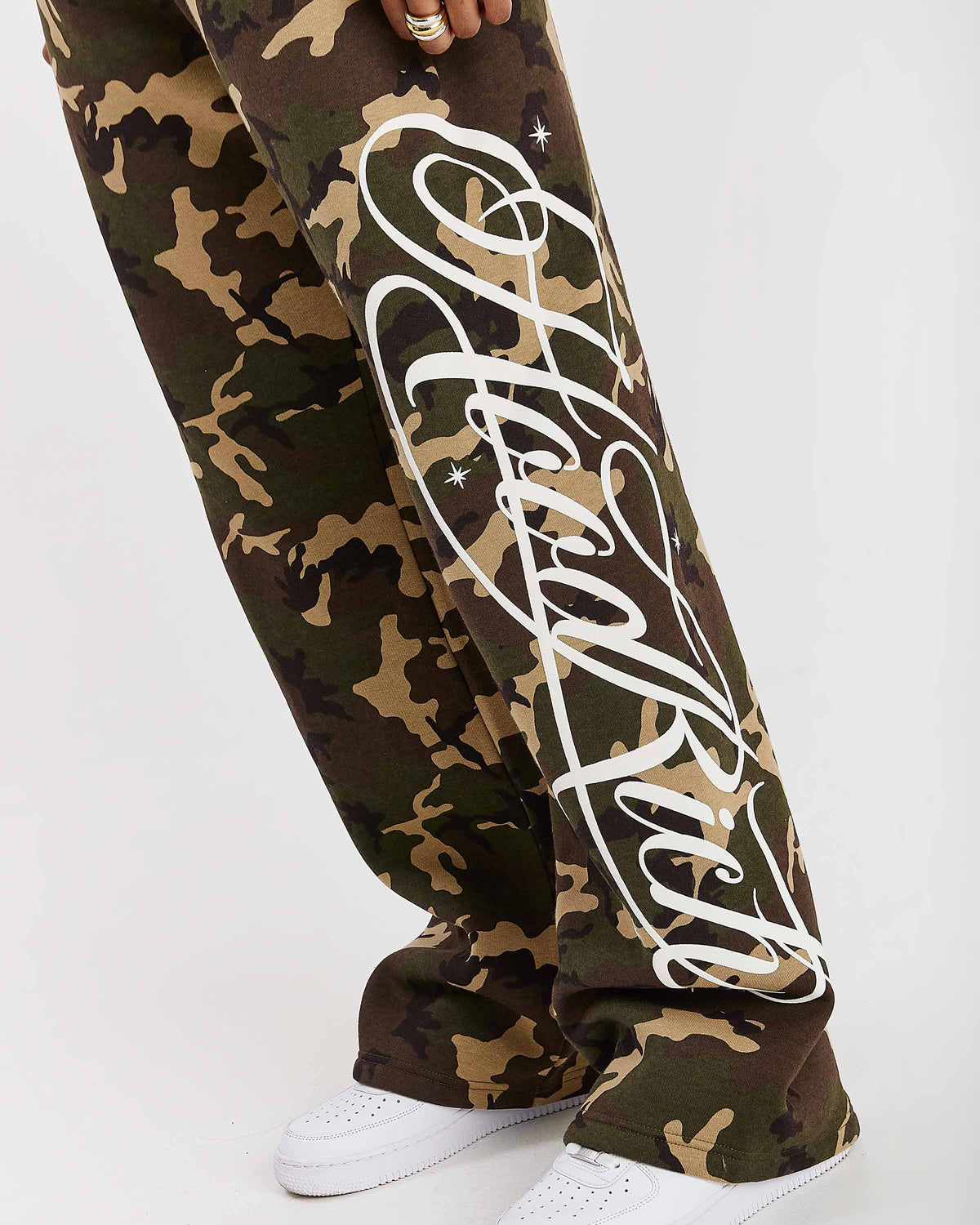 Displays a model wearing the Camo 'Hoodrich' branded women's Solace Full Tracksuit featuring the branding details