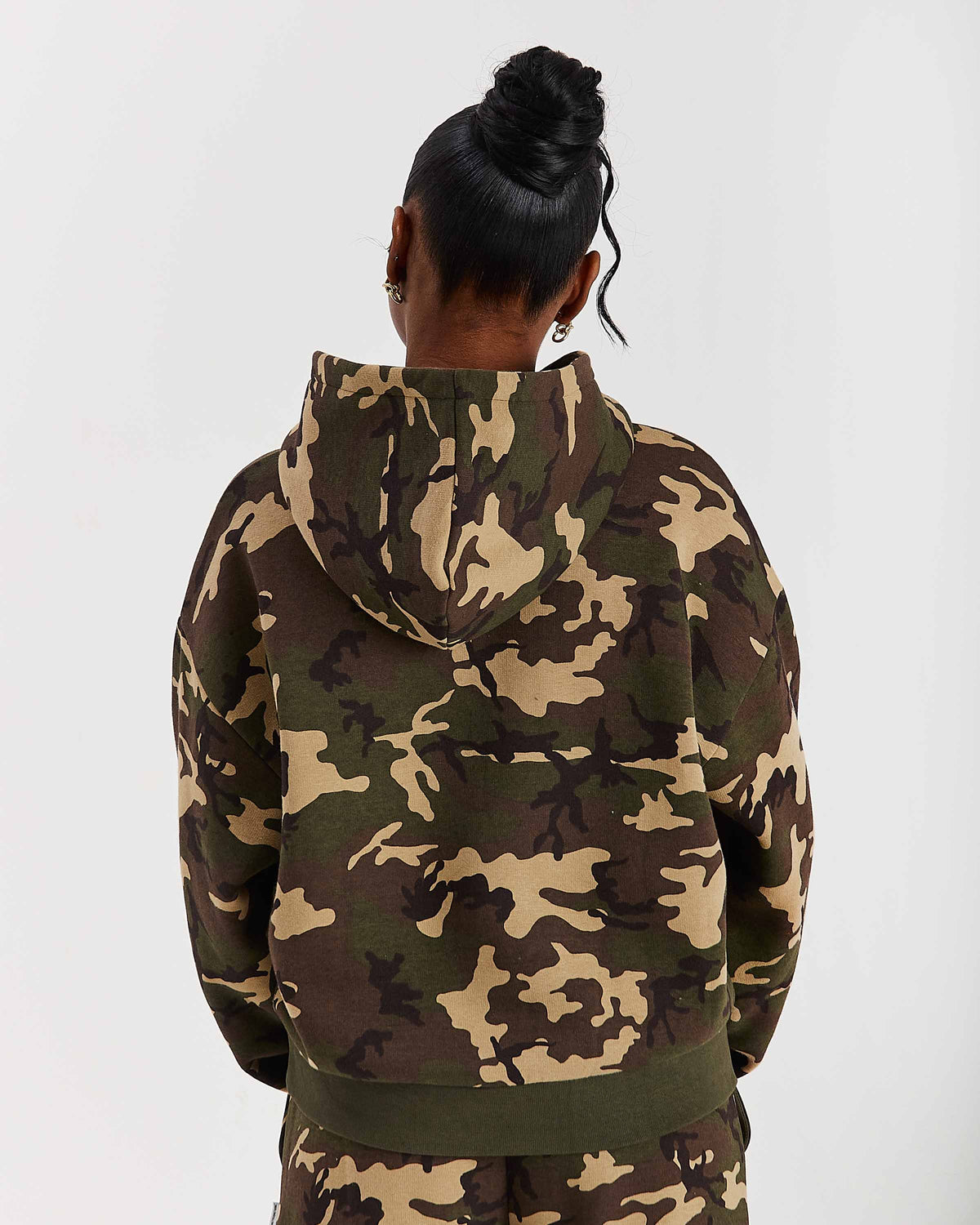 Displays a model wearing the Camo 'Hoodrich' branded women's Solace Full Tracksuit