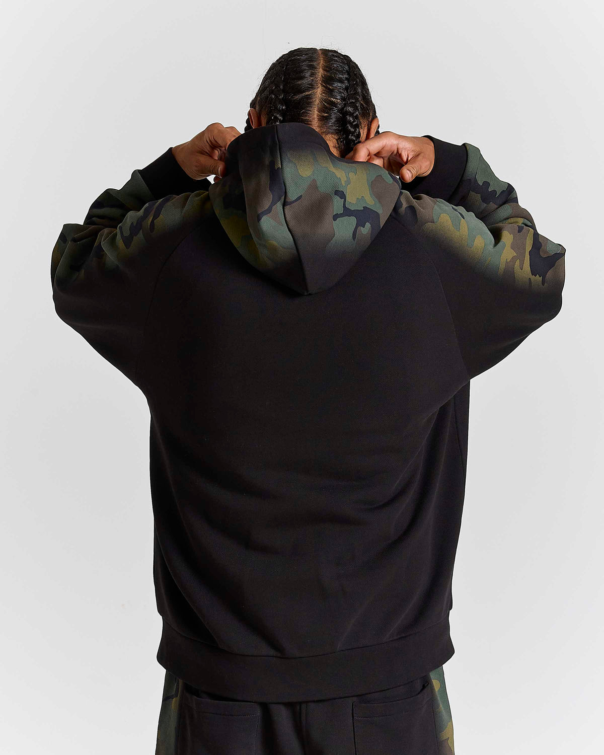 Displays a model wearing the Black Camo 'Hoodrich' branded men's Shade Matching Shorts Set 