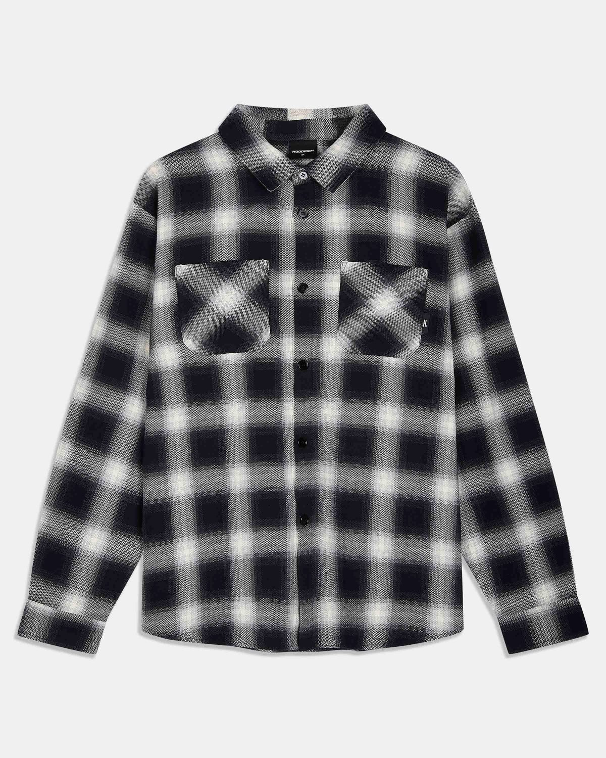 A long-sleeve button-up flannel shirt with a black and white plaid pattern, featuring two buttoned chest pockets, shown against a light gray background.