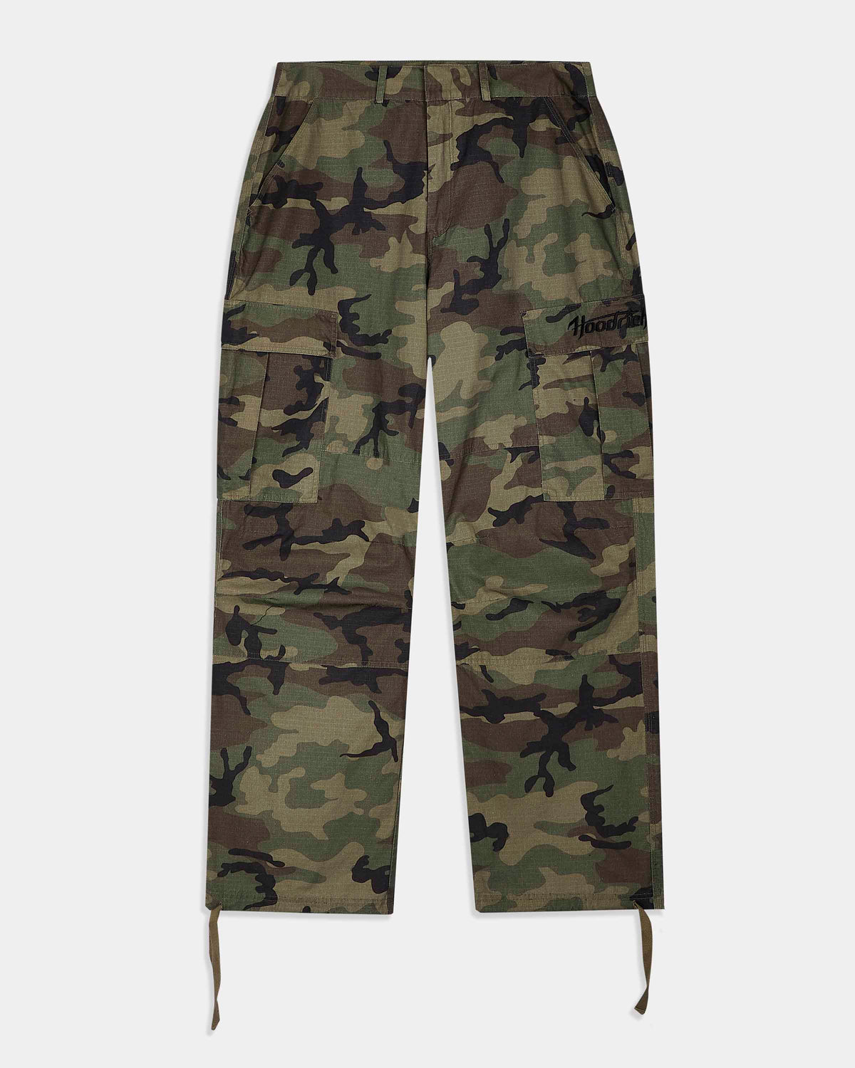 A pair of camouflage cargo pants with a green, brown, and black camo pattern, featuring a drawstring waist and hem, and a small black embroidered logo on the right thigh.