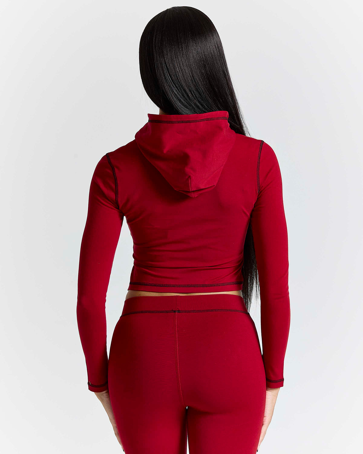 Displays a model wearing the Red 'Hoodrich' branded women's Gleam Full Tracksuit
