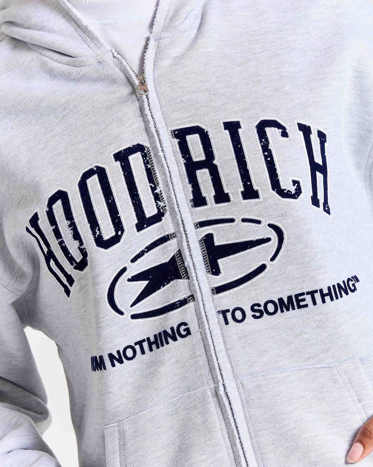 Gray hoodie with 'Hood Rich, I'm Nothing to Something' text and logo on a white background