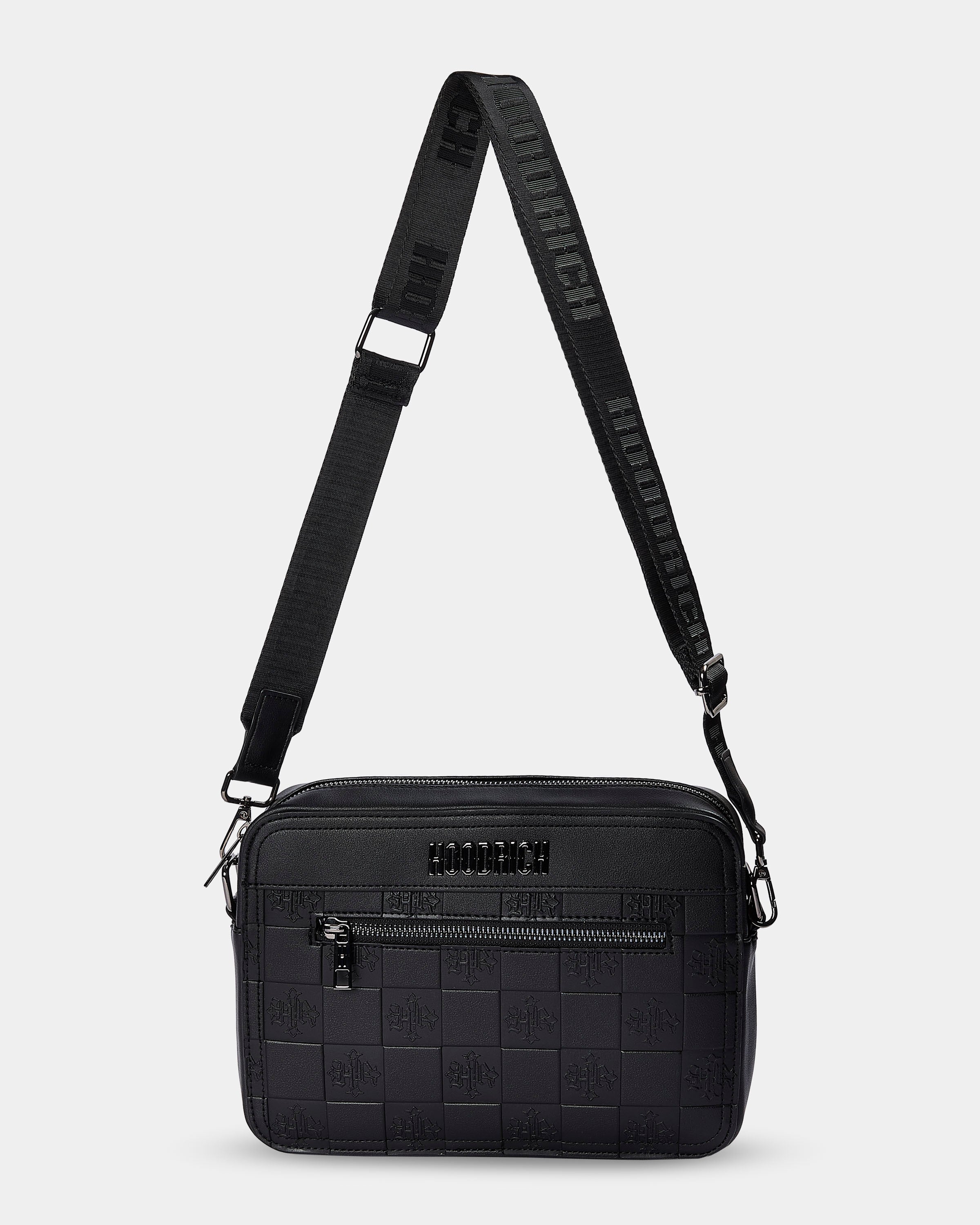 Black textured crossbody bag with a strap on a light gray background
