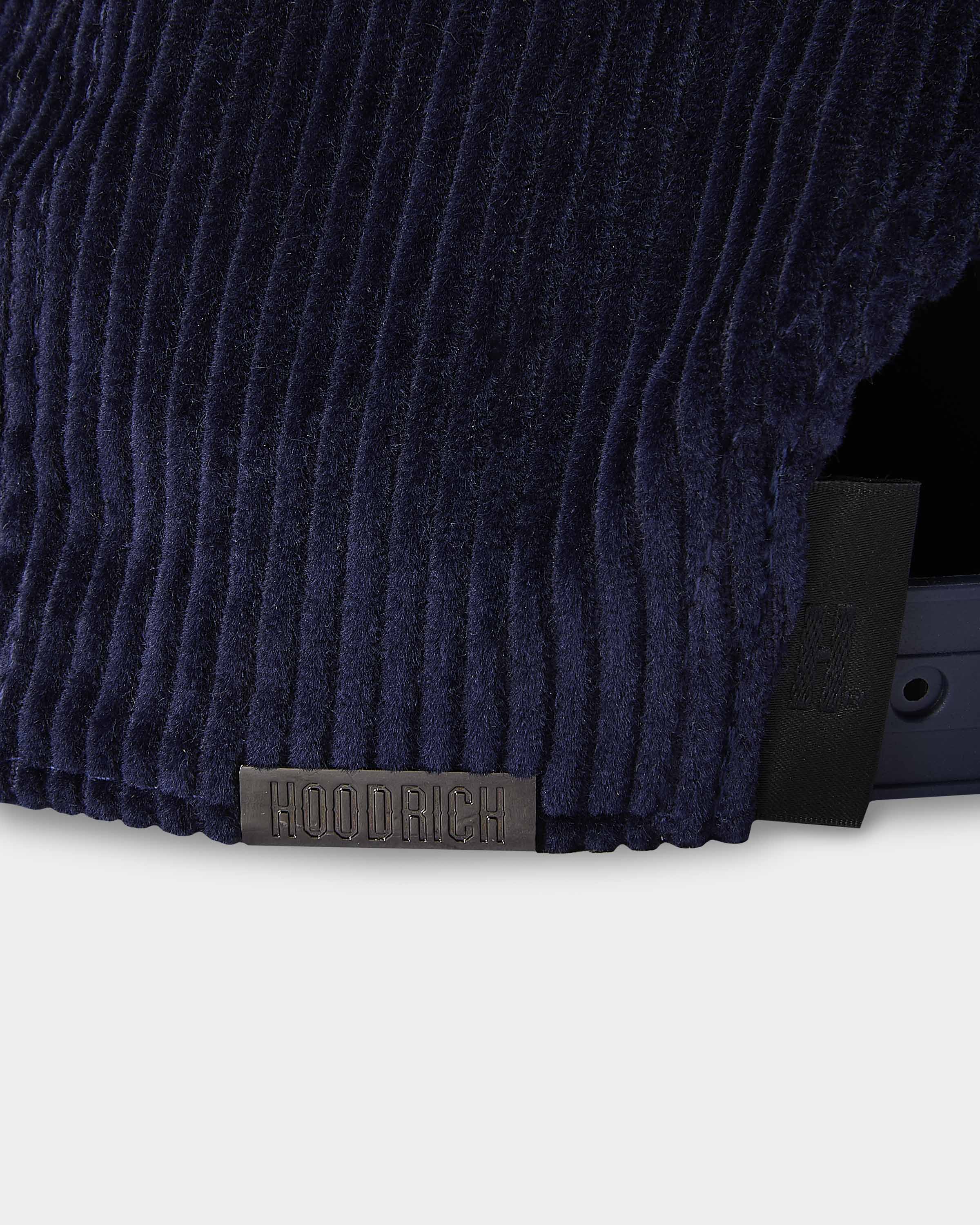 Navy blue textured fabric with a brand label on a white background