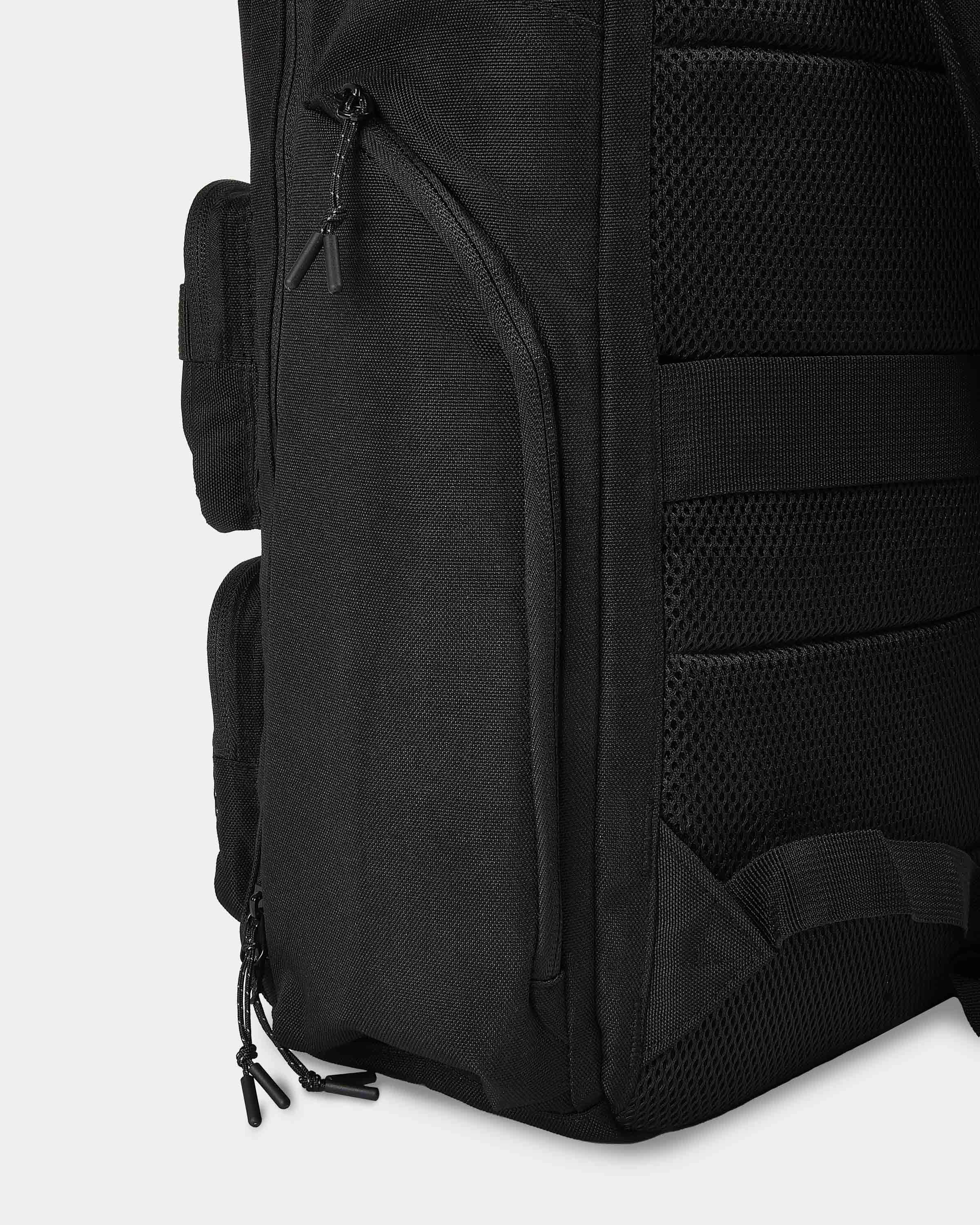 Black backpack with multiple compartments and straps on a white background