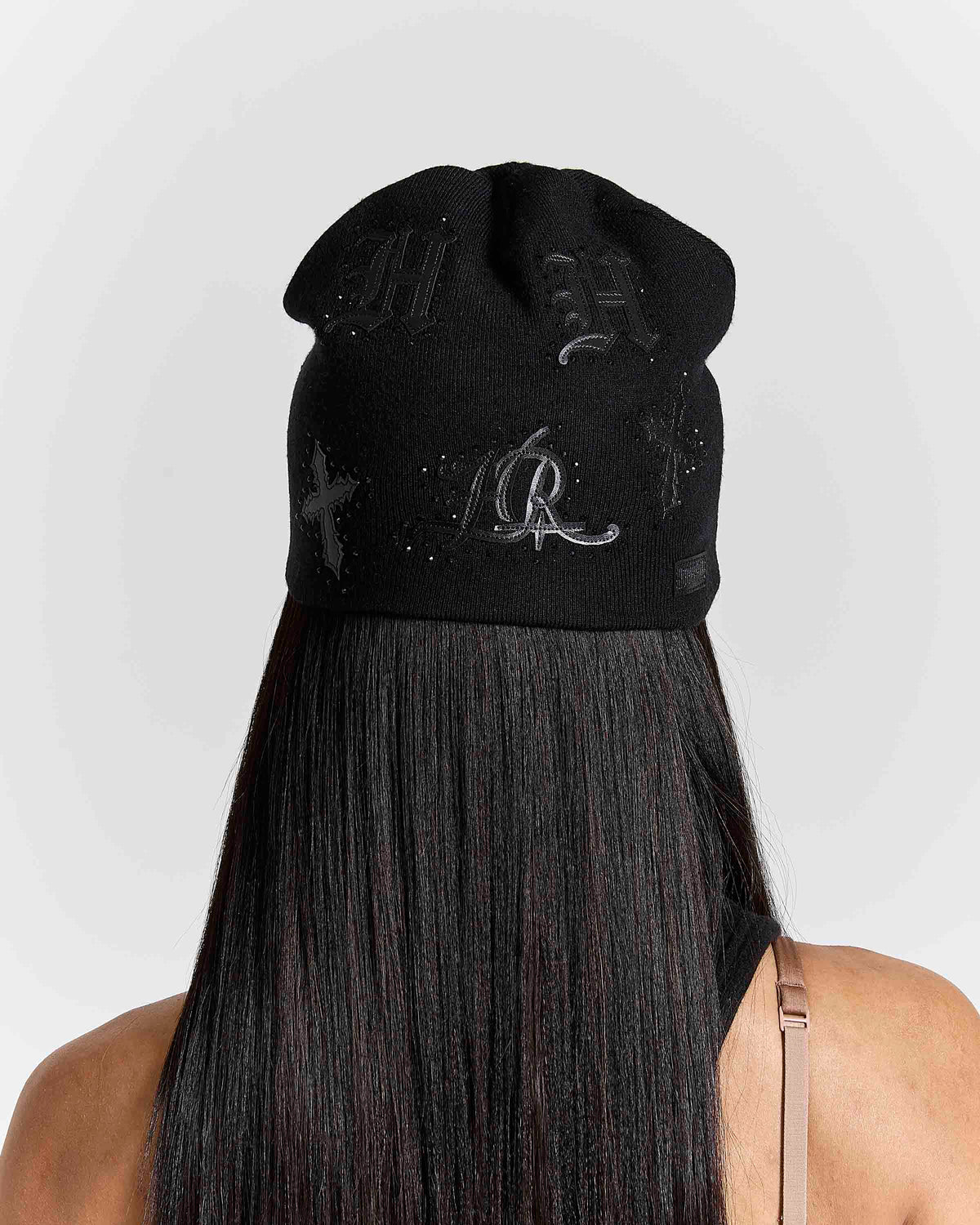 Displays a model wearing the black 'hoodrich' branded Scar Knitted Fitted Beanie 