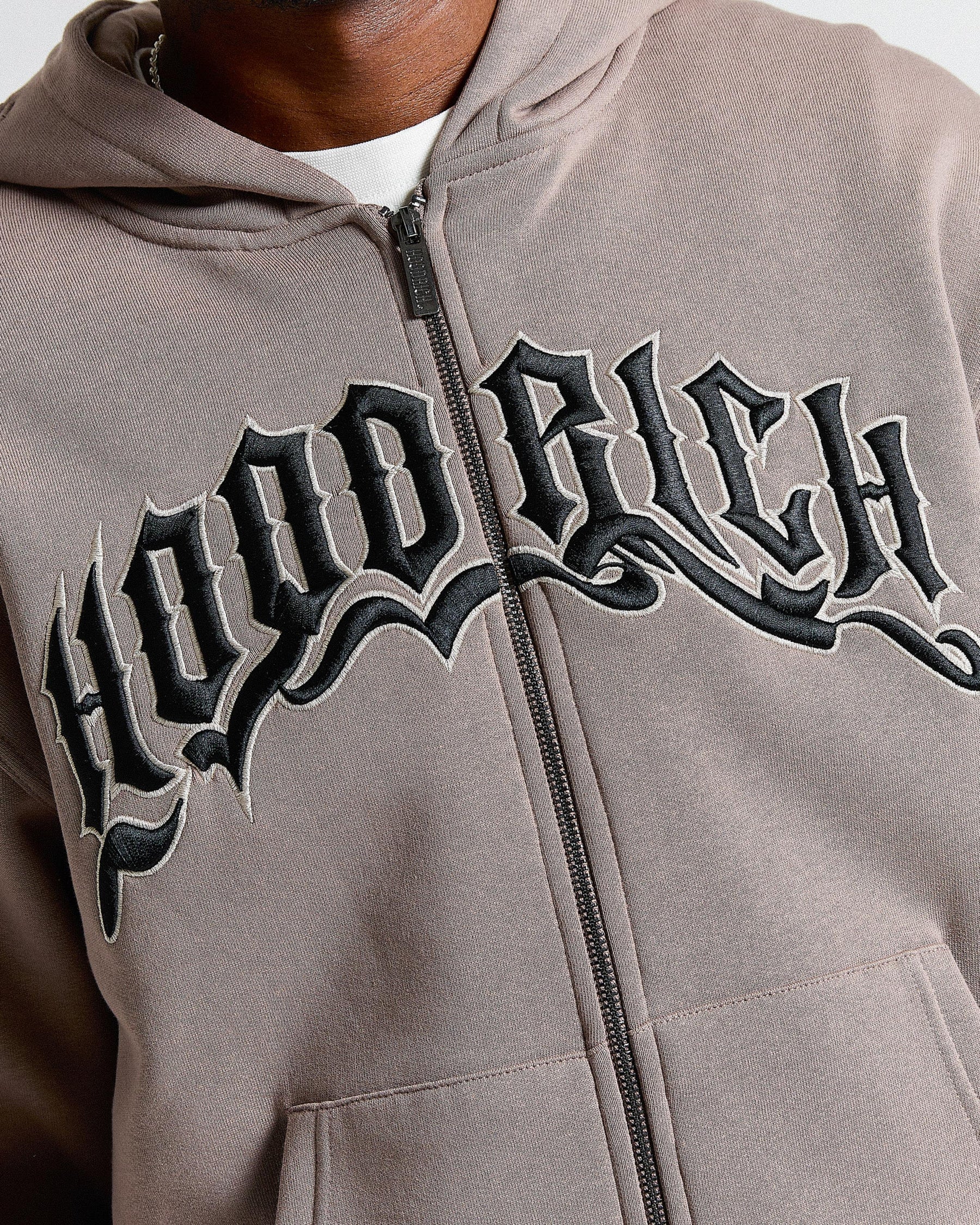 Beige hoodie with 'Hood Rich' text on a white background
