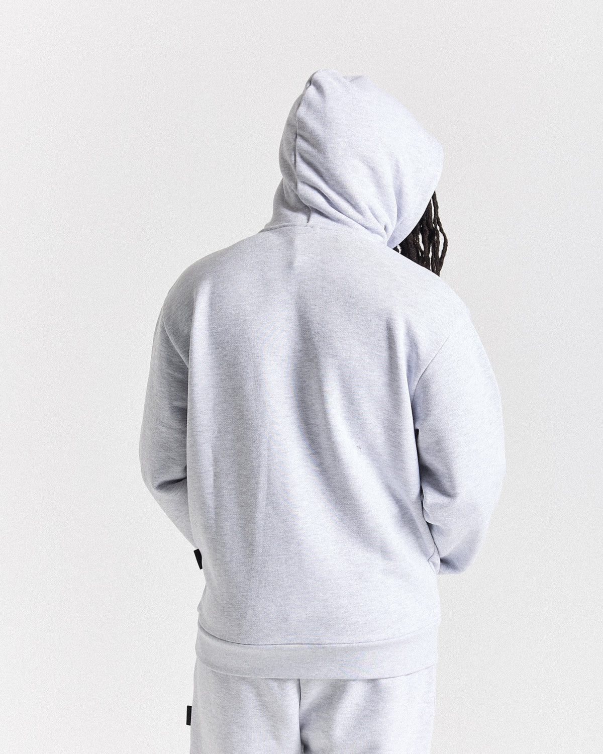Displays a model wearing the light grey 'Hoodrich' branded men's Asthrich Full Tracksuit 