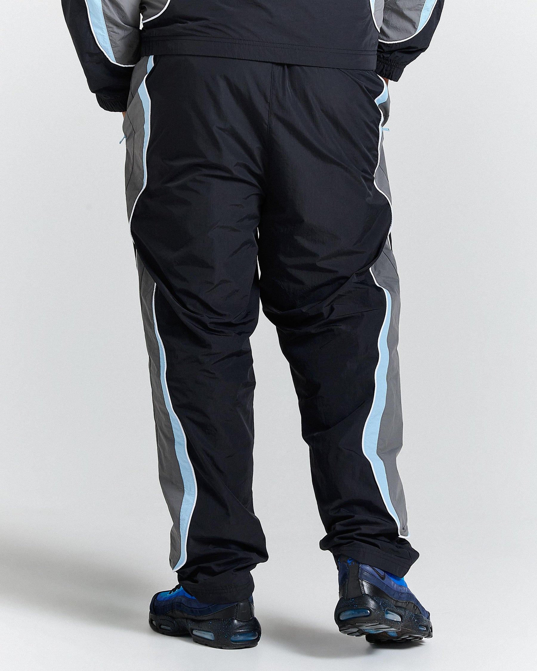 Black and gray tracksuit with blue stripes on a white background
