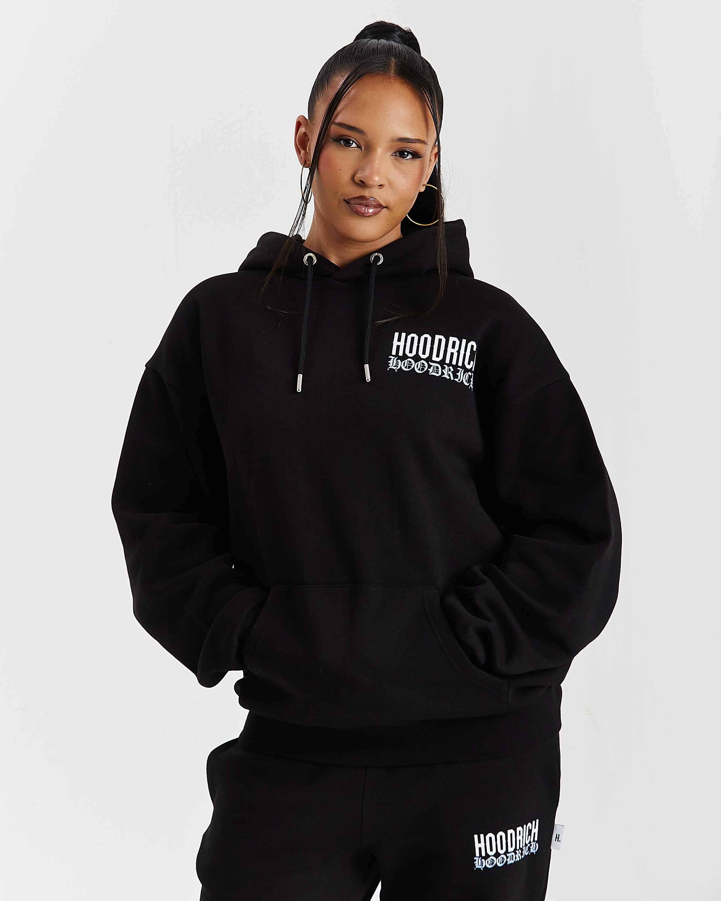 Person wearing a black hoodie with 'HOODRICH' branding on a white background