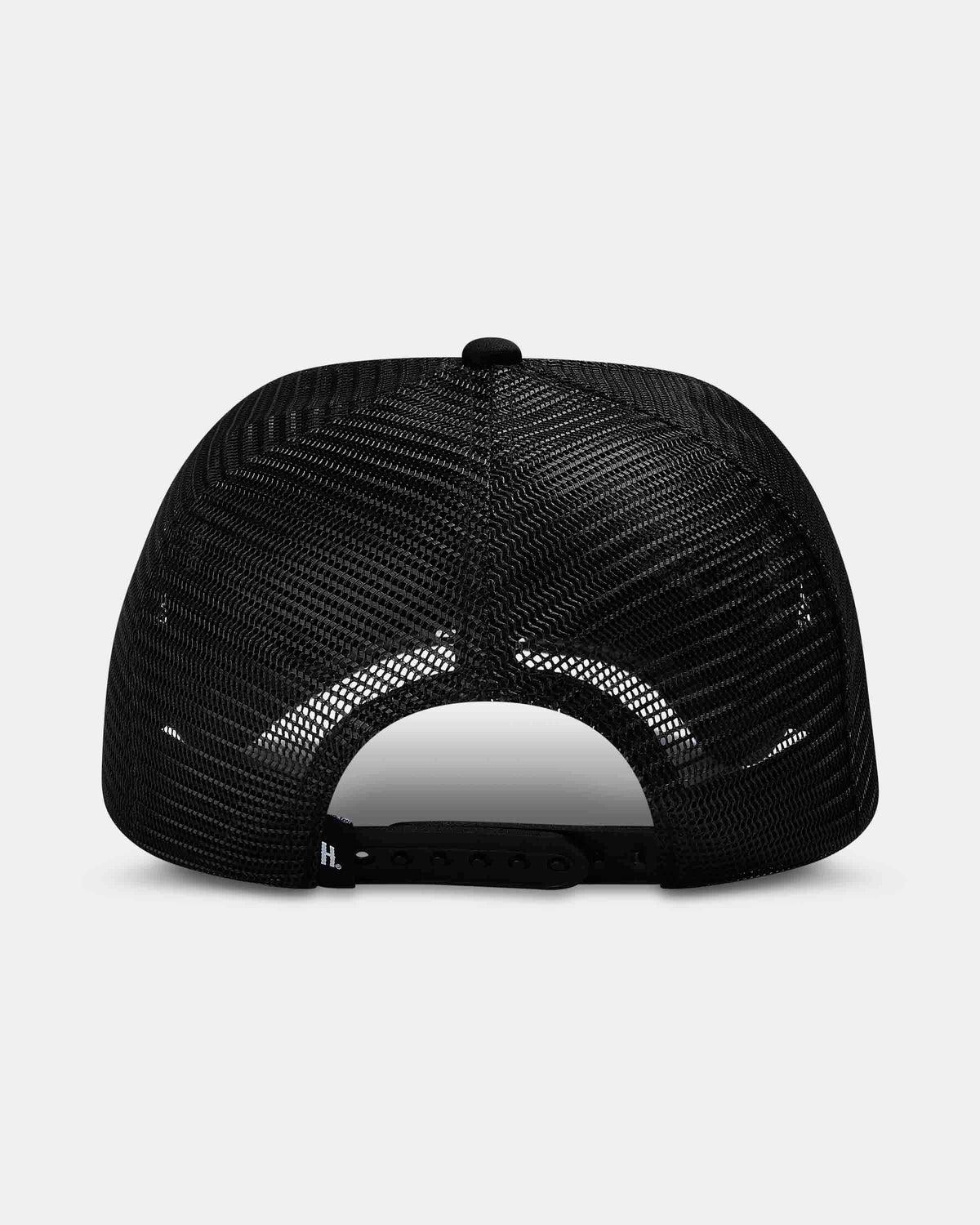 Black trucker-style cap shown from the back, featuring a black mesh back and an adjustable snap closure, photographed on a light gray background.