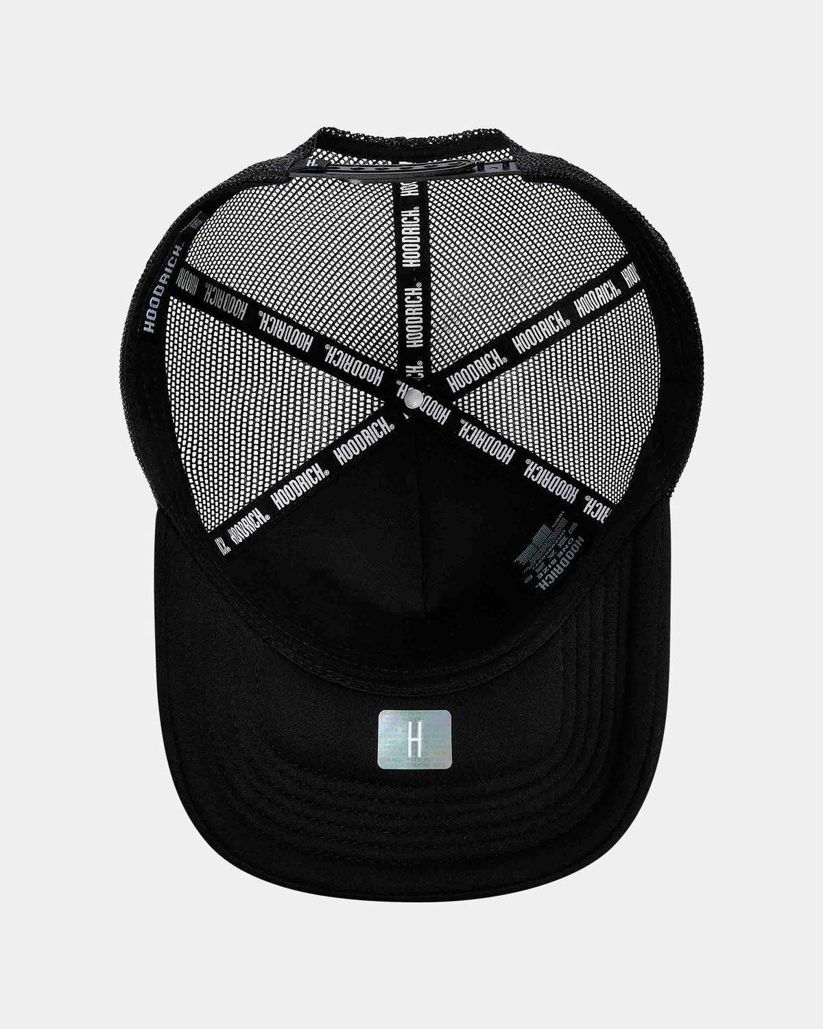 A black trucker-style baseball cap with a black mesh back and a white printed brand name 'HOODRICH' repeated across the back straps. A small silver square logo is visible on the front of the brim.