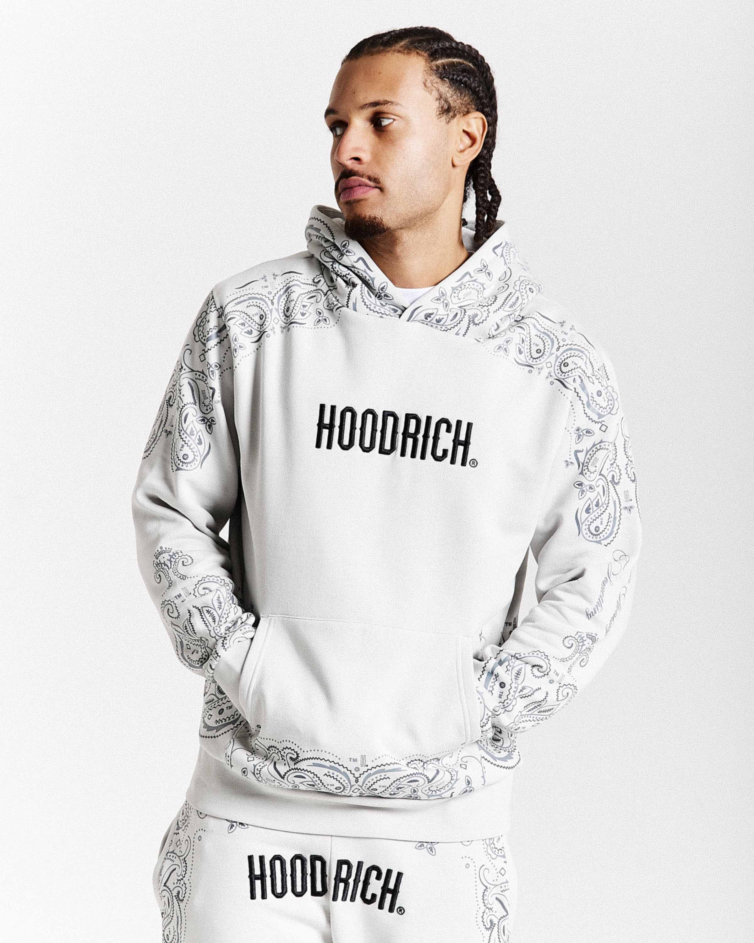 Person wearing a white hoodie with 'HOODRICH' branding on a white background